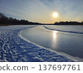 A shiny, smooth ice rink on the frozen lake at dusk during the winter 137697761