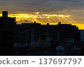 Crepuscular rays visible between buildings 137697797