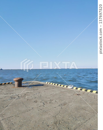 The endless horizon: a view from the harbor breakwater. The endless horizon: a view from the harbor breakwater. 137697820