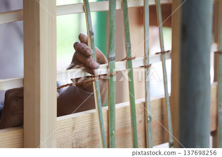 A man weaving a bamboo komai A man weaving a bamboo komai 137698256
