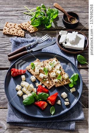 Rye crispbread open sandwich with feta and peppers Rye crispbread open sandwich with feta and peppers 137698268