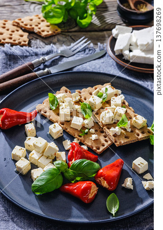 Rye crispbread open sandwich with feta and peppers Rye crispbread open sandwich with feta and peppers 137698269