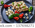 Rye crispbread open sandwich with feta and peppers 137698271