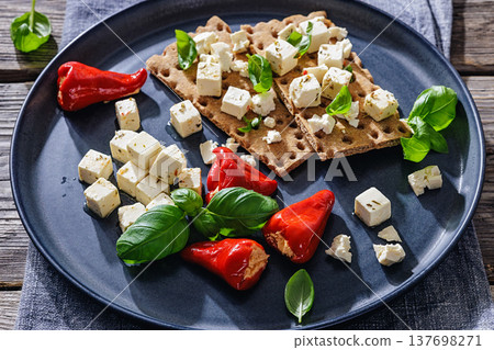 Rye crispbread open sandwich with feta and peppers 137698271