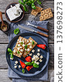 Rye crispbread open sandwich with feta and peppers 137698273