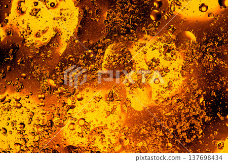 Swirling golden liquid with air bubbles abstract macro metallic background Swirling golden liquid with air bubbles abstract macro metallic background 137698434