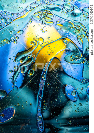Multi colored abstract oil bubbles on water vibrant blue and yellow mix Multi colored abstract oil bubbles on water vibrant blue and yellow mix 137698441