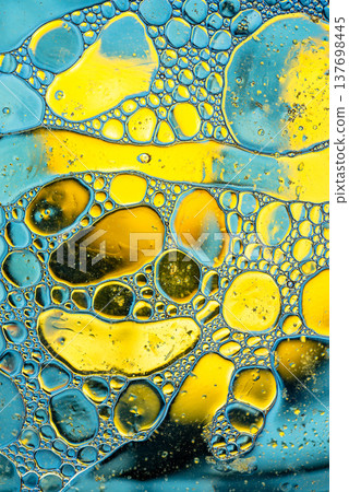 Abstract yellow and blue oil bubbles on water macro texture organic cells pattern Abstract yellow and blue oil bubbles on water macro texture organic cells pattern 137698445