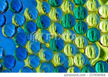 Dense blue and yellow spheres in liquid macro science background Dense blue and yellow spheres in liquid macro science background 137698468