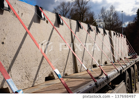 Heavy concrete blocks secured on a transport trailer 137698497