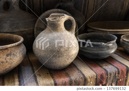 A collection of ancient clay pottery jugs and bowls A collection of ancient clay pottery jugs and bowls 137699132