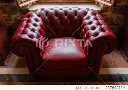 A vintage red leather tufted armchair in Chesterfield style 137699134