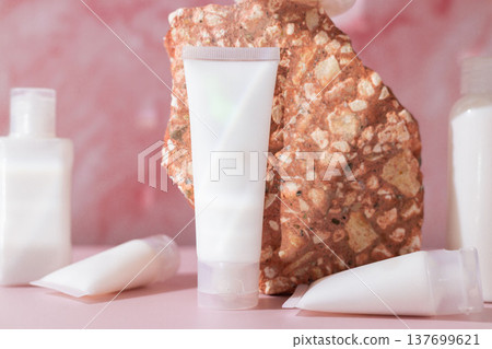 Minimal cosmetic skincare lotion tubes with natural stone on pink background, beauty product packaging mockup Minimal cosmetic skincare lotion tubes with natural stone on pink background, beauty product packaging mockup 137699621
