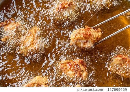 Cooking fried chicken Cooking fried chicken 137699669