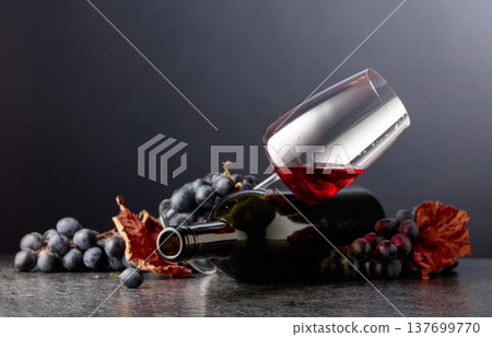Grapes and red wine on a black background. Grapes and red wine on a black background. 137699770