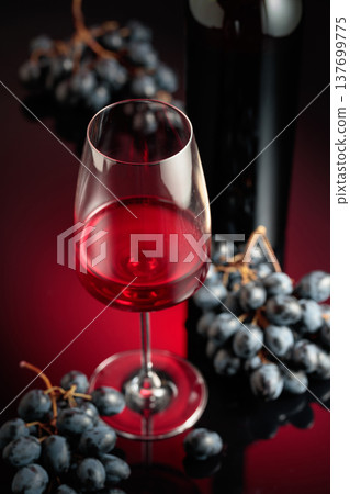 Red wine and juicy blue grapes. Red wine and juicy blue grapes. 137699775
