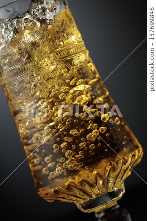 White wine is poured into a glass. White wine is poured into a glass. 137699848