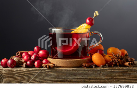 Winter drink with spices, cranberries, and citrus fruits on a black background. 137699958