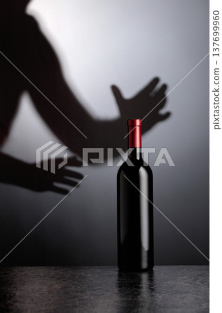 Bottle of red wine on a black table. Bottle of red wine on a black table. 137699960