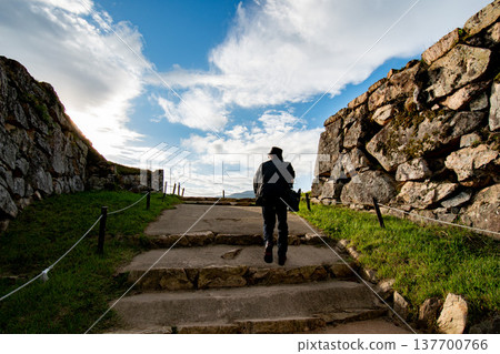 A man climbing stairs under a blue sky A man climbing stairs under a blue sky 137700766