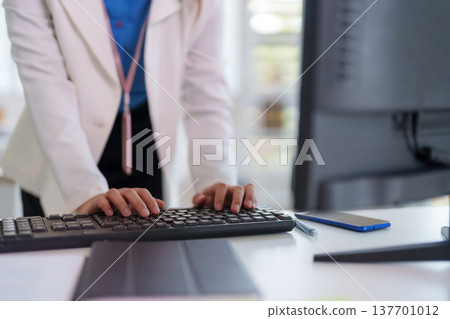 Professional adult hands typing keyboard computer data entry digital work office productivity modern workspace corporate environment 137701012