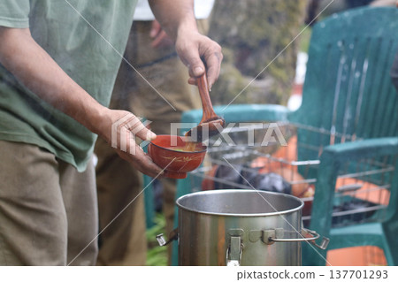 A man serving miso soup A man serving miso soup 137701293