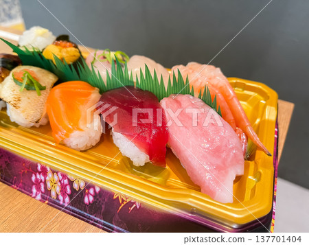 Nigiri sushi served in a plastic container. Includes lean tuna, medium fatty tuna, salmon, and more. Nigiri sushi served in a plastic container. Includes lean tuna, medium fatty tuna, salmon, and more. 137701404