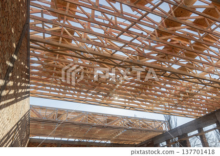 Wooden Roof Trusses Construction on Building Site with Blue Sky Background.roofing works 137701418