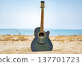 A guitar placed on the beach 137701723