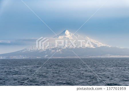 A winter view of snow-capped Mount Rishiri from the sea. 137701959