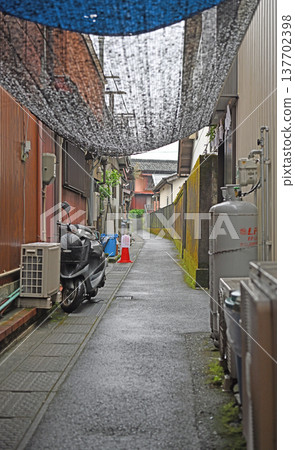 The fishing village of Kure in the rain: wet alleyways and old streets enveloped in silence. The fishing village of Kure in the rain: wet alleyways and old streets enveloped in silence. 137702398