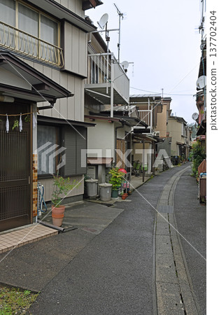 The fishing village of Kure in the rain: wet alleyways and old streets enveloped in silence. The fishing village of Kure in the rain: wet alleyways and old streets enveloped in silence. 137702404