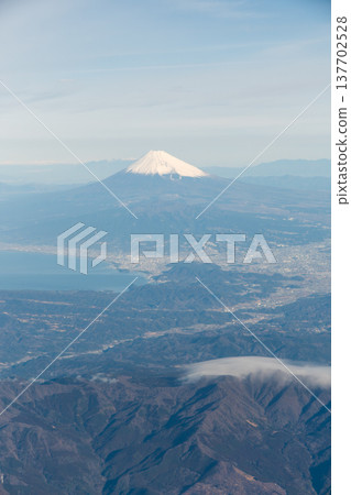 The majestic view of Mount Fuji on a clear day, as seen from an airplane. 137702528