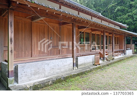 A shrine in Kure on a rainy day: the beautiful wooden shrine office and the rain-soaked grounds. A shrine in Kure on a rainy day: the beautiful wooden shrine office and the rain-soaked grounds. 137703365