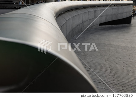This low-angle perspective emphasizes the architectural leading lines, drawing the eye along the smooth, sweeping curvature of the stainless steel handrail. This low-angle perspective emphasizes the architectural leading lines, drawing the eye along the smooth, sweeping curvature of the stainless steel handrail. 137703880
