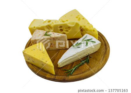 Set of various types of cheese on wooden cutting board isolated on white background 137705163