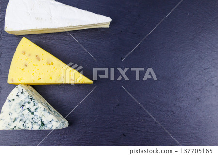 Set of various types of cheese on black slate background. Top view 137705165