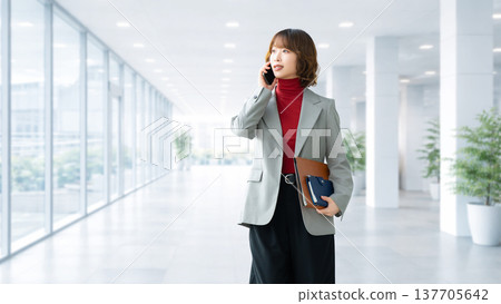 Woman/businesswoman talking on smartphone Woman/businesswoman talking on smartphone 137705642
