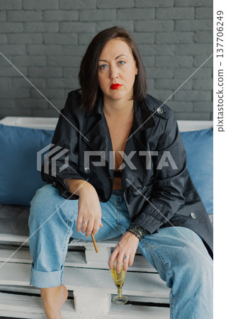 Beautiful woman posing for photographer with 137706249