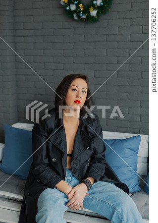 Woman posing for camera in photo studio on wooden Woman posing for camera in photo studio on wooden 137706252