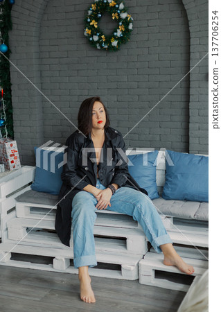 Woman posing for camera in photo studio on wooden Woman posing for camera in photo studio on wooden 137706254