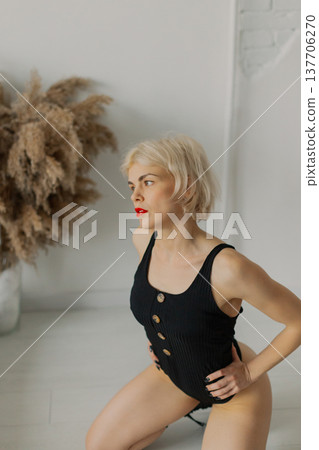 Beautiful woman posing for photographer against Beautiful woman posing for photographer against 137706270