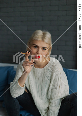 Beautiful woman posing for photographer with 137706313