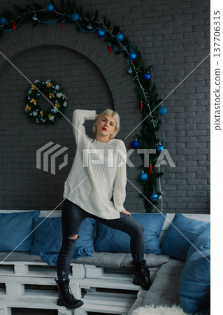 Woman posing for camera in photo studio on wooden Woman posing for camera in photo studio on wooden 137706315