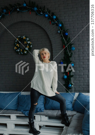 Woman posing for camera in photo studio on wooden Woman posing for camera in photo studio on wooden 137706316