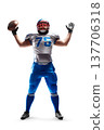 Sport victory. American Football player holding the ball in his hand. Joy in football. Sport. Isolated on white background 137706318