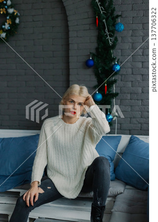 Woman posing for camera in photo studio on wooden Woman posing for camera in photo studio on wooden 137706322