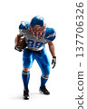 American Football in action. Team play. A young, agile american football player holding the ball. Football fight. Sports emotions. In action 137706326