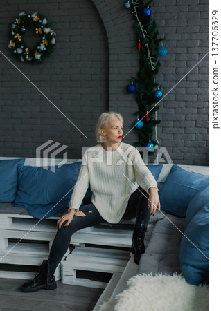 Woman posing for camera in photo studio on wooden 137706329