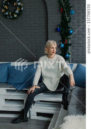 Woman posing for camera in photo studio on wooden Woman posing for camera in photo studio on wooden 137706330